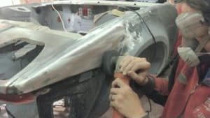 TR7 wing being stripped of paint